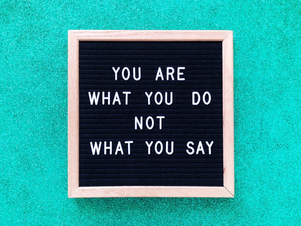 A sign that reads. 'you are what you do, not what you say.'